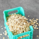 Close up picture of whole grain oats in miniature container, selective focus. - PhotoDune Item for Sale