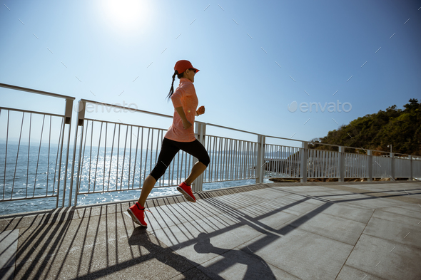 Healthy lifestyle fitness sports woman runner running up stairs on seaside trail - Stock Photo - Images