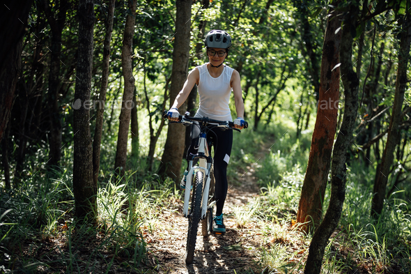 Mountain biking in summer forest - Stock Photo - Images