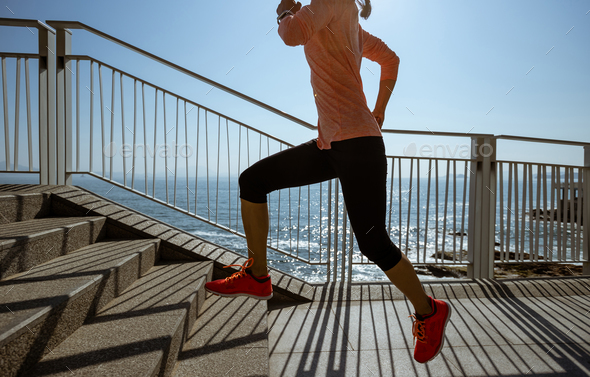 Healthy lifestyle fitness sports woman runner running on seaside trail - Stock Photo - Images
