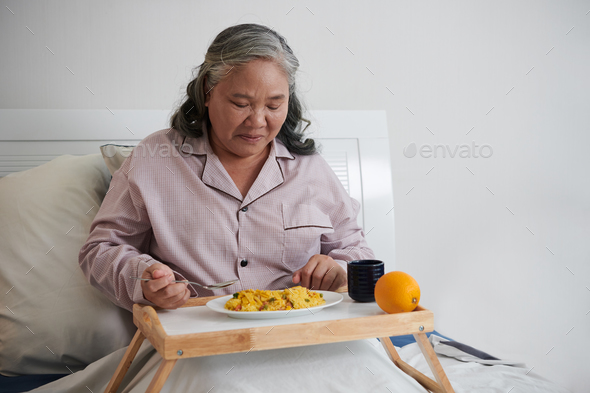 Woman Eating Lunch in Bed