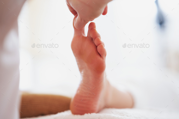 Woman having foot reflexology massage in salon - Stock Photo - Images