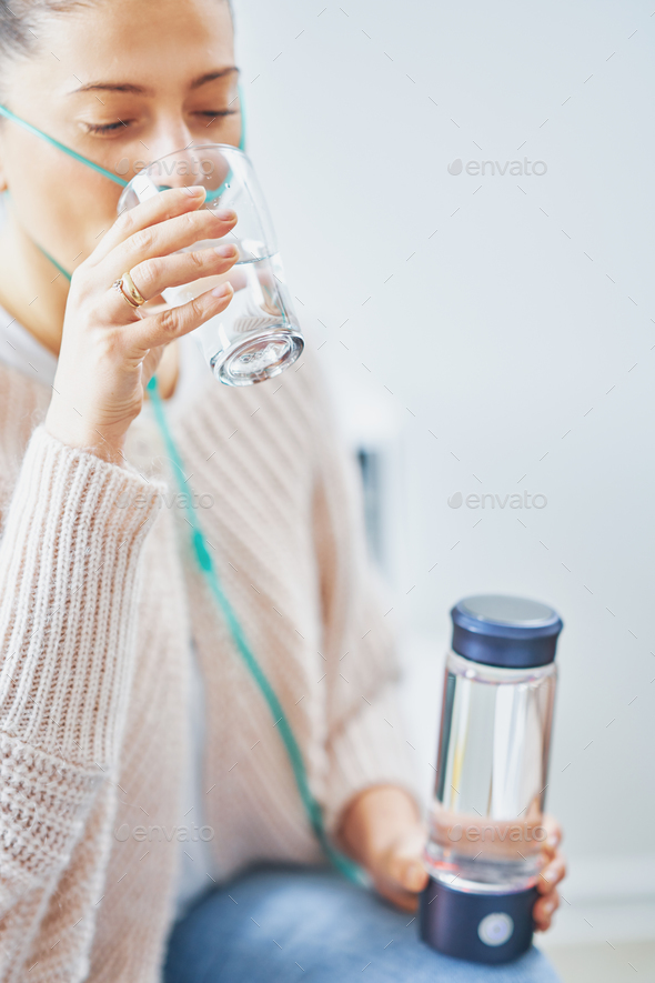 Picture of woman having hydrogen water in hand - Stock Photo - Images