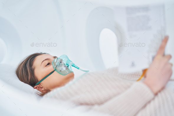 Picture of brunette woman in oxygen cabin - Stock Photo - Images