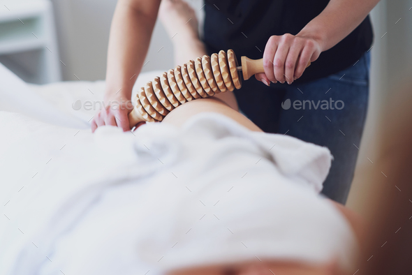 Woman at massage therapy with wooden tools - Stock Photo - Images