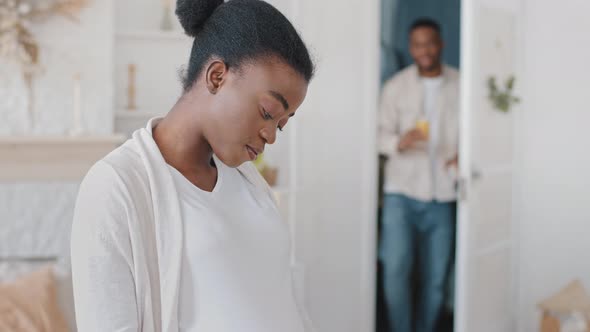 African Pregnant Woman Black Future Mother Stands at Home Holding Belly with Hands Caring Afro alt