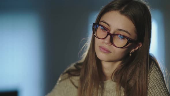 Tired Student Notes at Desk Takes Off Glasses and Thinks When Leaning on Hand alt