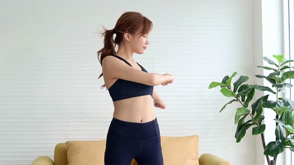 Healthy beautiful Asian woman Exercise in the living room at home. alt
