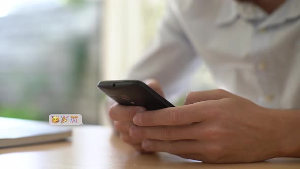 Young man chatting on smartphone alt