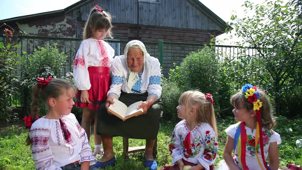 An Old Grandmother is Sitting on the Street and Reading a Book alt