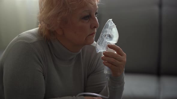 Sick Elderly Woman Making Inhalation Elderly Woman and Nebulizer alt