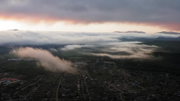 Aerial Drone Sunrise View Over Foggy Countryside with Wooden Houses alt