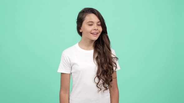 Amazed Kid Long Curly Hair Looking Form Side to Side Showing Hush Gesture Quiet