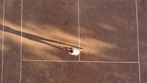 Drone Top Down Footage of Man Tennis Player Holds Competition in Tennis on Sandy Court alt