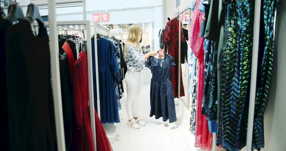 Woman With Dress in Front of Mirror