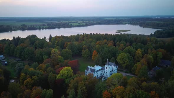 Stameriena Palace, Stameriena Lake at Sunset Aerial View in Autumn, Orthodox Church in Background. alt