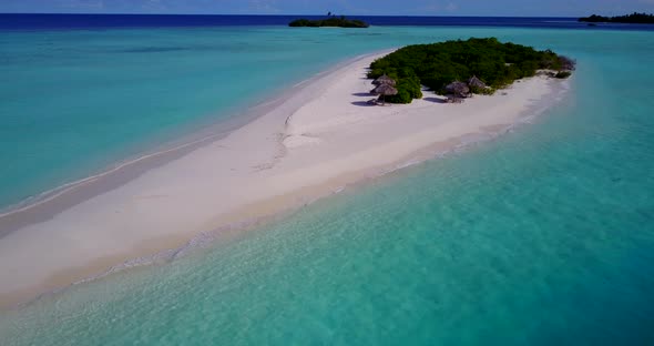 Wide angle birds eye travel shot of a sunshine white sandy paradise beach and blue sea background in alt