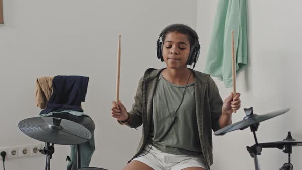 Girl Playing E-drums at Home alt