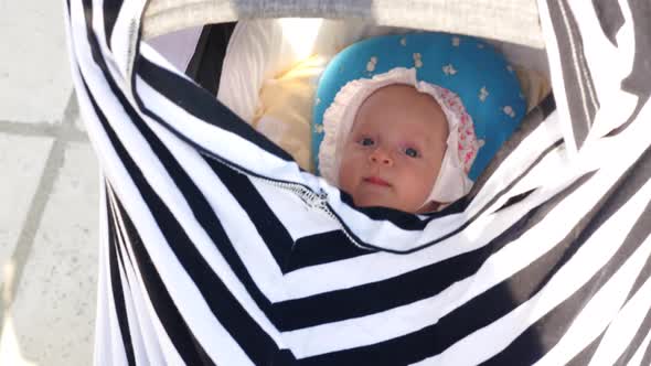 Lulling Baby Girl in Pram alt