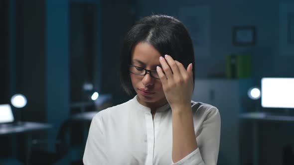 Portrait of Tired AfricanAmerican Businesswoman Standing in Dark Office Working Late alt