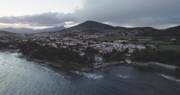 Aerial Over Carqueiranne Harbor with Mountains and Sunset in the Background