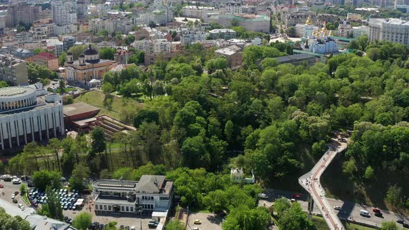 Summer flight in Kiev over the pedestrian bridge, tree crowns covered with green leaves. alt