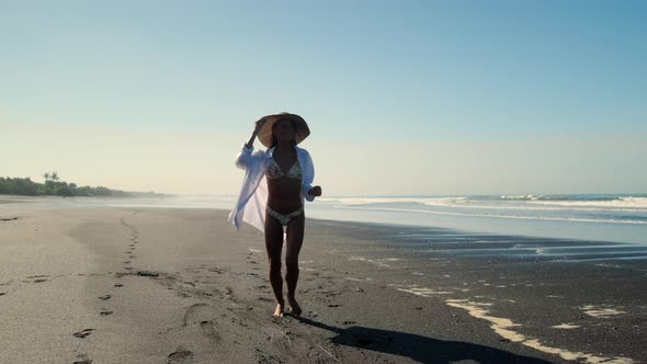 Woman is Running on Ocean Beach alt