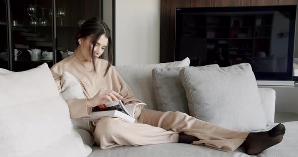 Dreamy Woman Sit Indoor Reading Book Enjoy Cozy Lazy Weekend at Modern Home alt