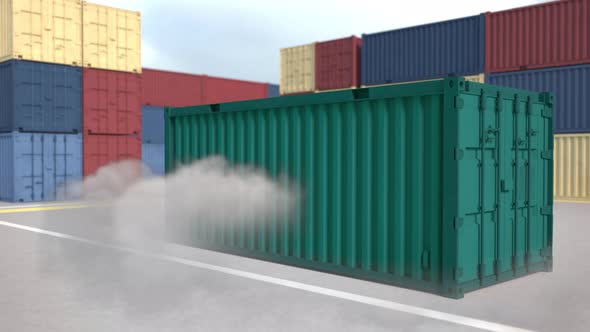 The green container falls with clouds of dust
