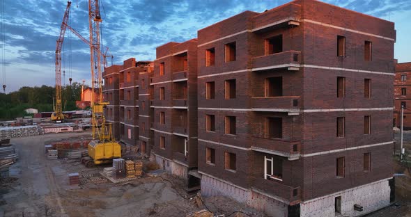Construction site of low-rise brick houses in summer. Aerial view alt
