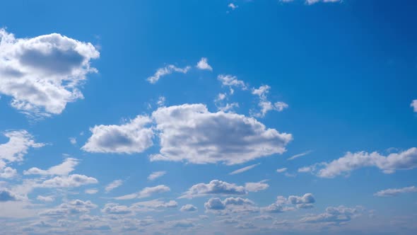 White Clouds Move and Dissolve in the Blue Sky Timelapse alt