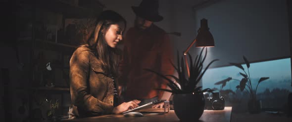 Man and women look at laptop alt