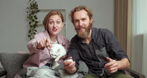 Young Couple Family Watching TV Emotionally React To Sports Program Movie Enjoy Online Video alt