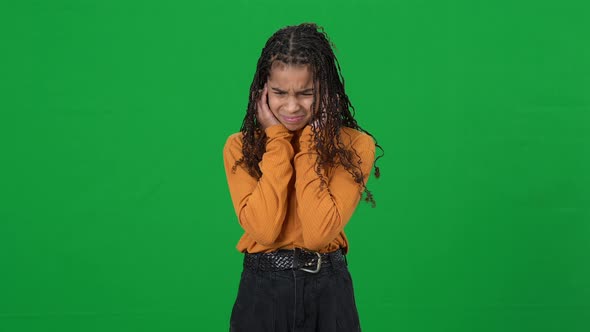 Portrait of Teen African American Girl Suffering From Loud Noise Looking at Camera Shaking Head No alt