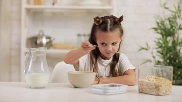 Child Put Cereal in a Bowl