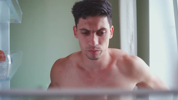 Hungry Man Opens the Empty Refrigerator and Takes the Leftover One Egg alt