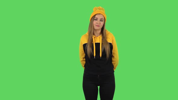 Modern Girl in Yellow Hat Is Waiting and Yawning with Boredom. Green Screen alt