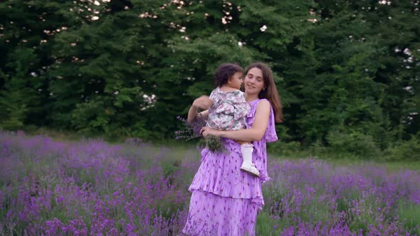 Mother Dancing with Child on Hands in Lavender Field alt
