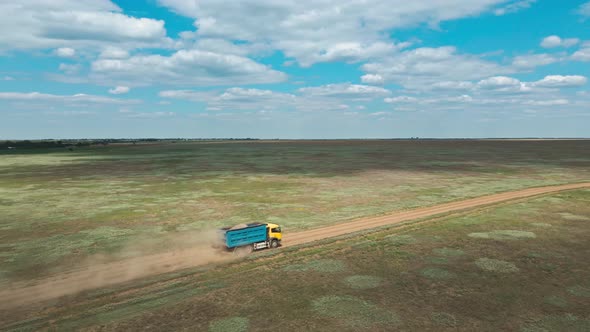 Aerial View Car and Truck Moving By Rustic Road Through Green Fields alt