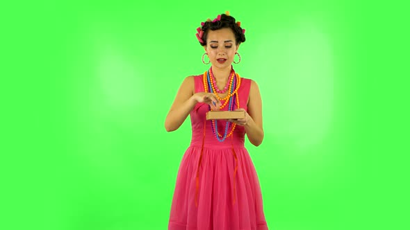 Girl Opens the Gift, Very Surprised and Rejoices. Green Screen alt