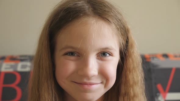 Portrait of Happy Blonde Girl Looking Into Camera and Laughing Indoor alt