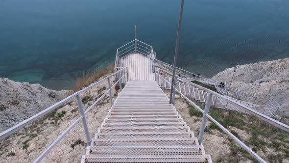 Scenic steep stairway leading down to sea coast alt