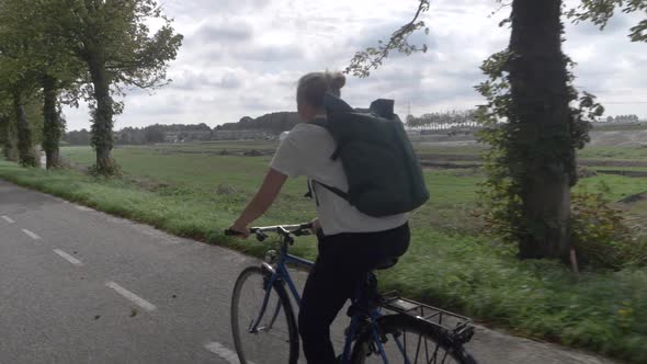 Young Determined Woman Cycling Home Through the Beautiful Dutch Countryside alt
