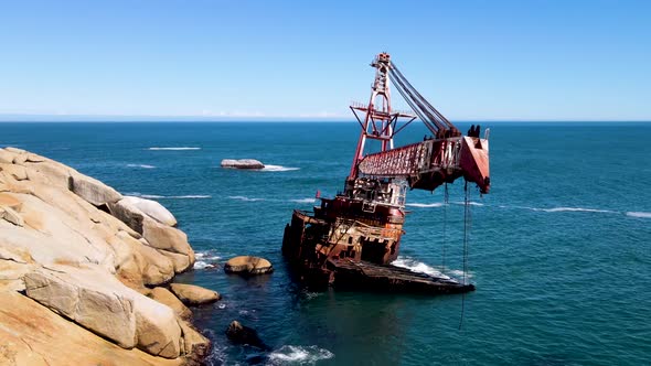 Aerial view of shipwreck crane barge is off the coast of Sandy Bay. alt
