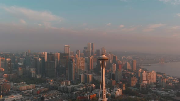 Aerial view of the Space Needle during sunset with Seattle's downtown in the background. alt