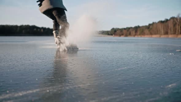 Closeup of a Man Training Hockey Stop on a Frozen Lake on a Sunny Day Alone