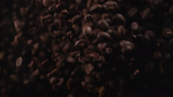 Coffee beans fly after being exploded. Slow Motion. alt