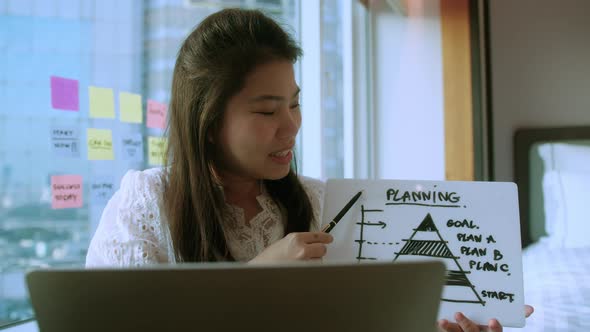 casual business discussion meeting asian female freelance work hand hold business chart alt