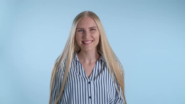 Attractive Young Lady Biting Her Lip and Smiling alt