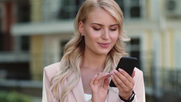 Portrait Businesswoman Using Smartphone. Girl Holding Phone in Hand Outdoor alt